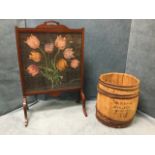 A mahogany firescreen with woolwork tapestry panel of tulips under glass with shaped feet,