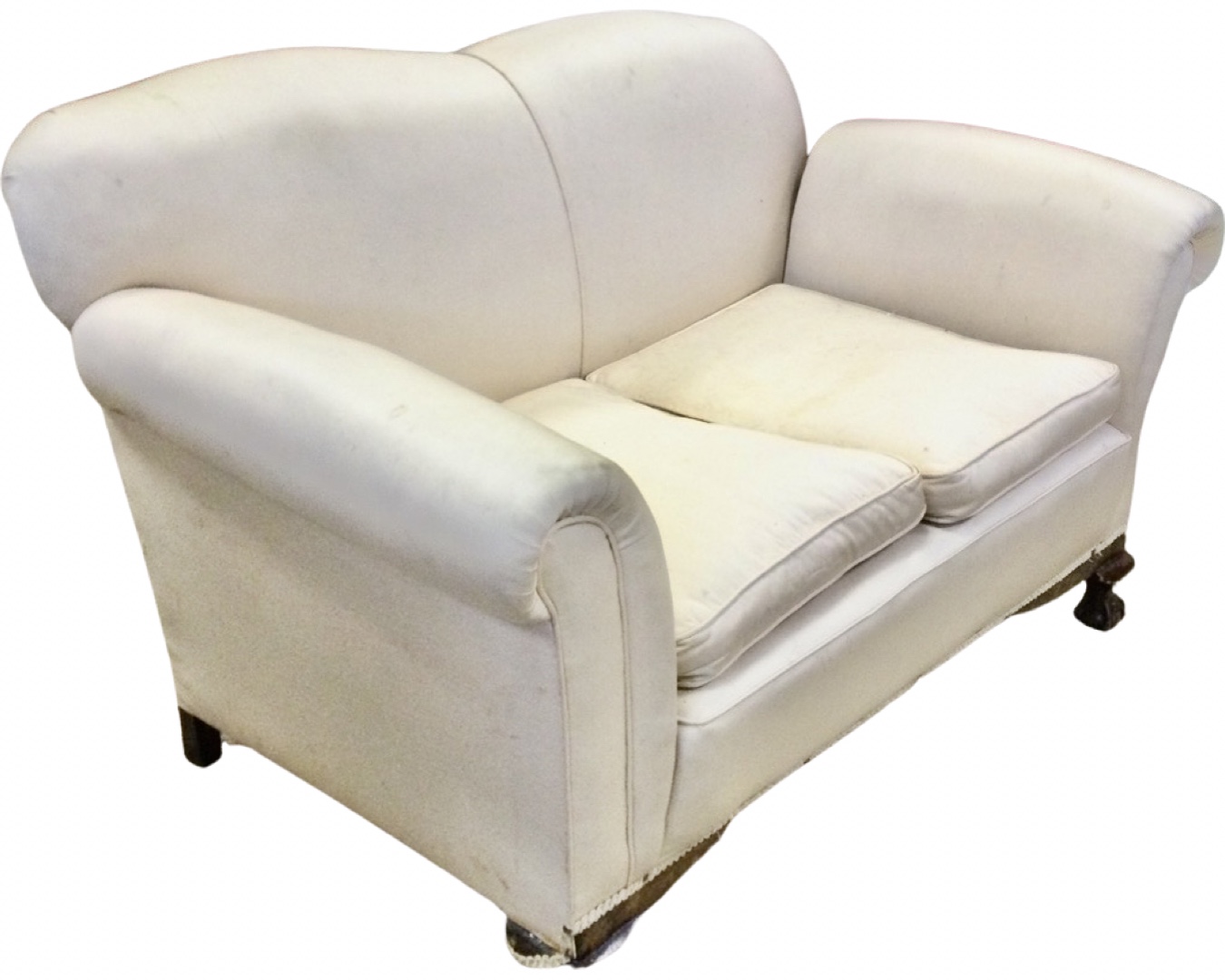 An Edwardian upholstered drop-arm two-seater sofa, with padded back above loose cushions, the sprung