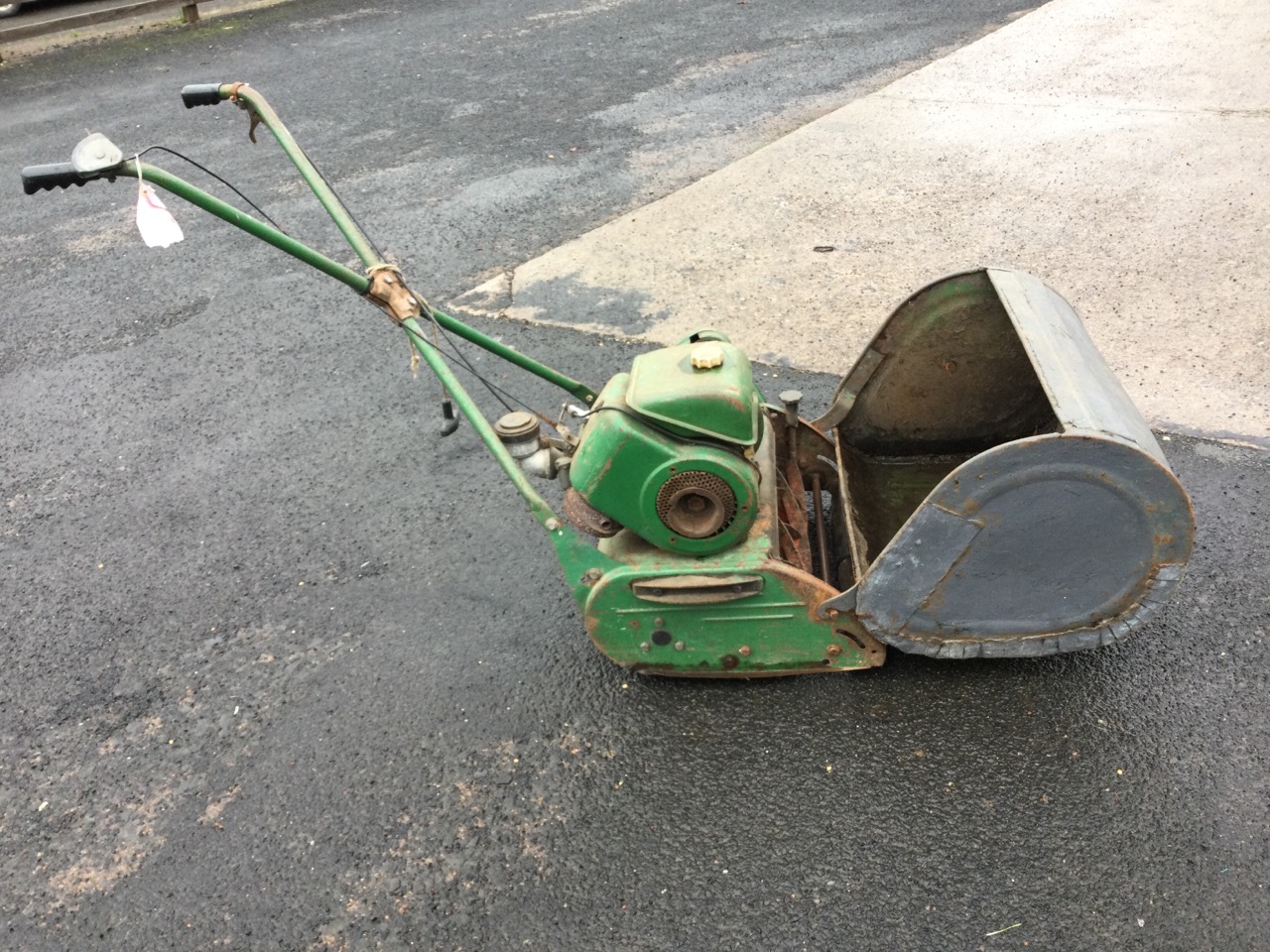 A petrol driven cylinder garden mower complete with grassbox, wood rollers, etc. (A/F)