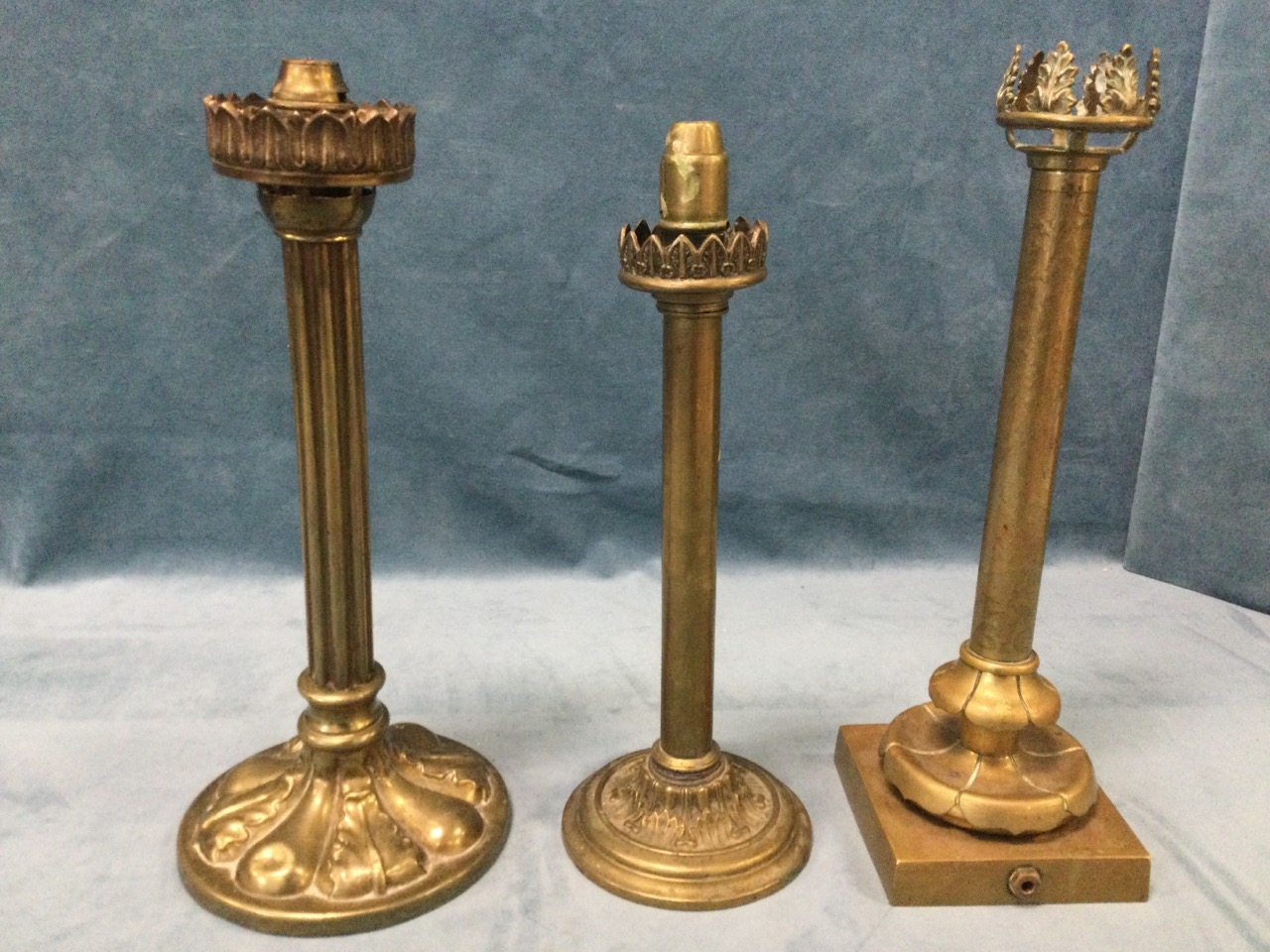 A Victorian brass candlelight with fluted column above a circular leaf cast weighted base, with
