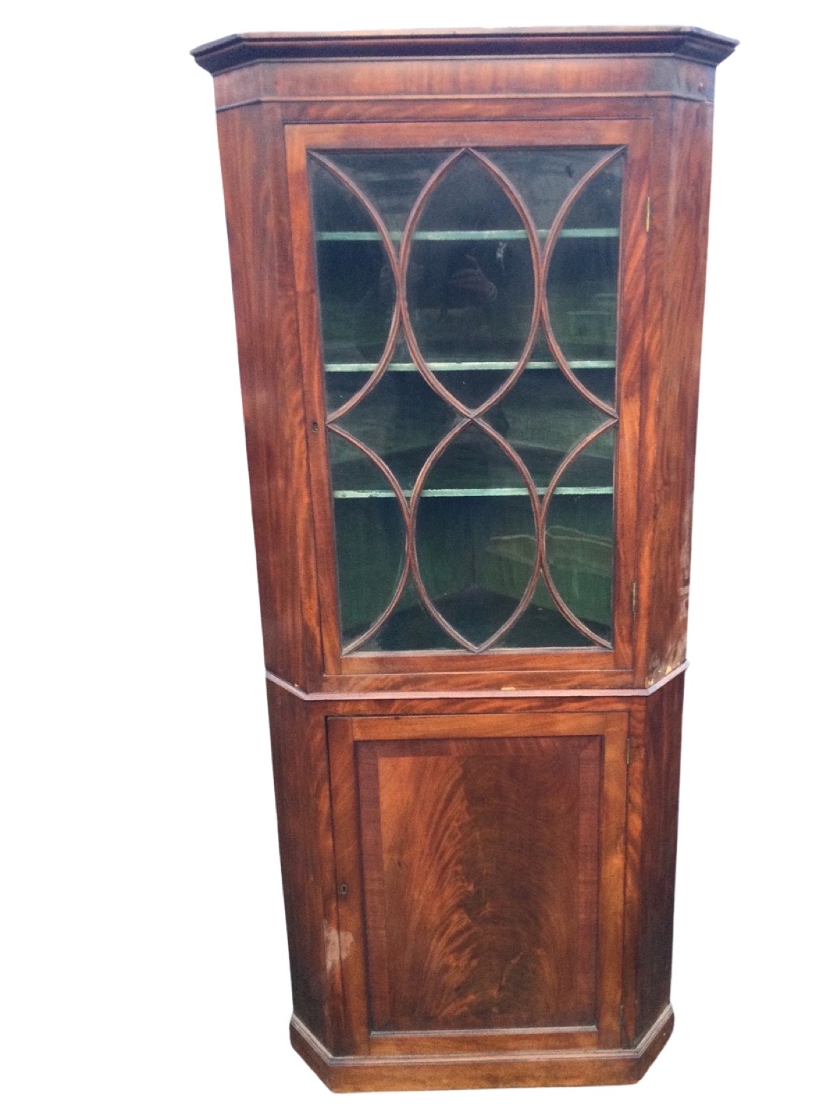 A nineteenth century mahogany corner cabinet with moulded cornice above an astragal glazed door