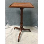 A square mahogany occasional table, the moulded tray top supported on a turned column, with shaped