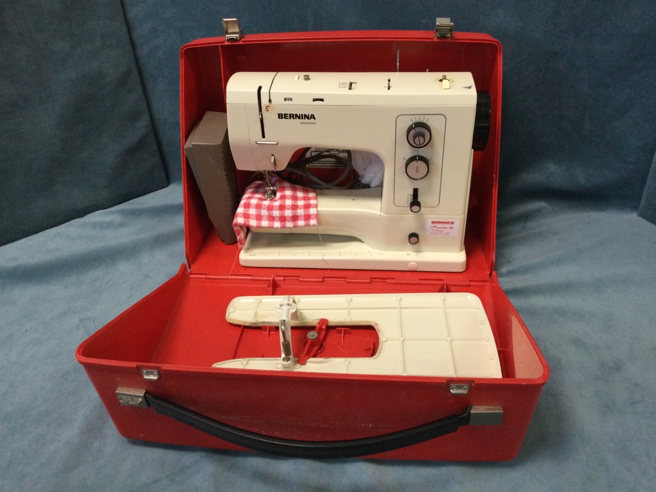 A cased Bernina electric sewing machine.