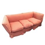 An Edwardian knole style sofa, the straight back flanked by flared arms above a sprung seat with