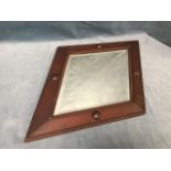 A diamond shaped 1950s oak framed mirror with bevelled plate in beaded frame mounted with turned