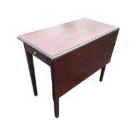 A Stag mahogany dining table, the moulded top with rule-jointed drop leaf above a frieze drawer with