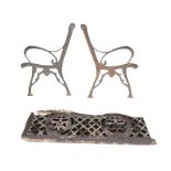 A cast iron bench with art nouveau style scrolled ends and arched latticework back centred by