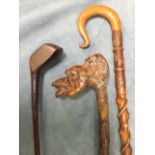 A carved and twisted stick with scrolled crook style handle; a Victorian golf club with wood shaft