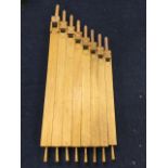 A decorative set of eight square hardwood organ type pipes, with tubular wall fixings to the