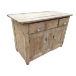 A Victorian pine dresser base, with rounded rectangular top above glass knobbed drawers, having