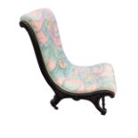 A late Victorian ebonised nursing chair with later button upholstery, the scrolled frame with carved