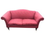 A damask upholstered two seater camel back sofa with splayed scrolled arms above a sprung seat