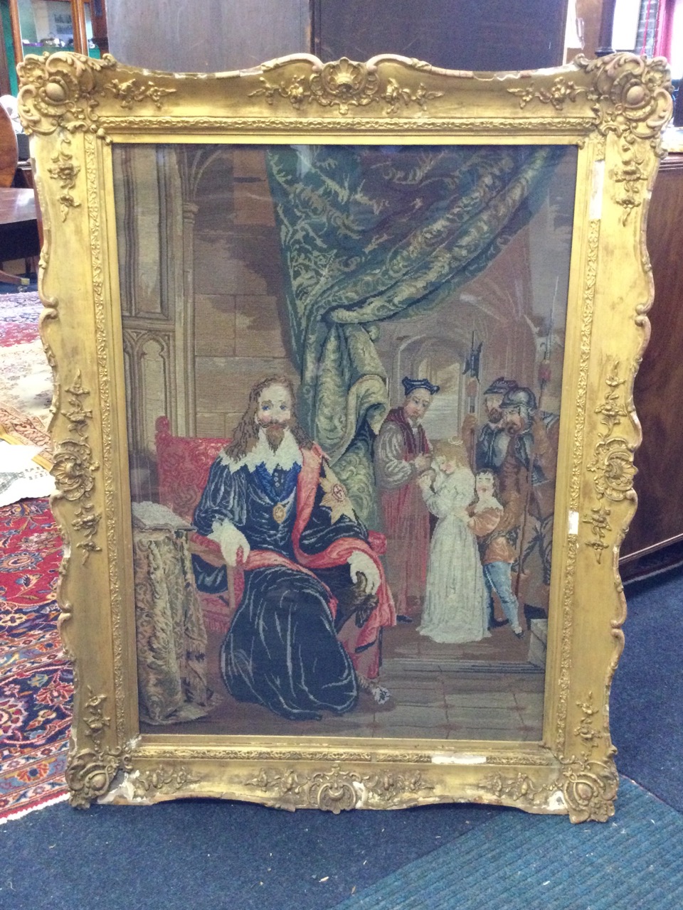 A large Victorian woolwork tapestry depicting an interior scene with seated King Charles with