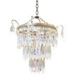 A silver plated glass chandelier with three tiers of crystal drops supported by chains, the top