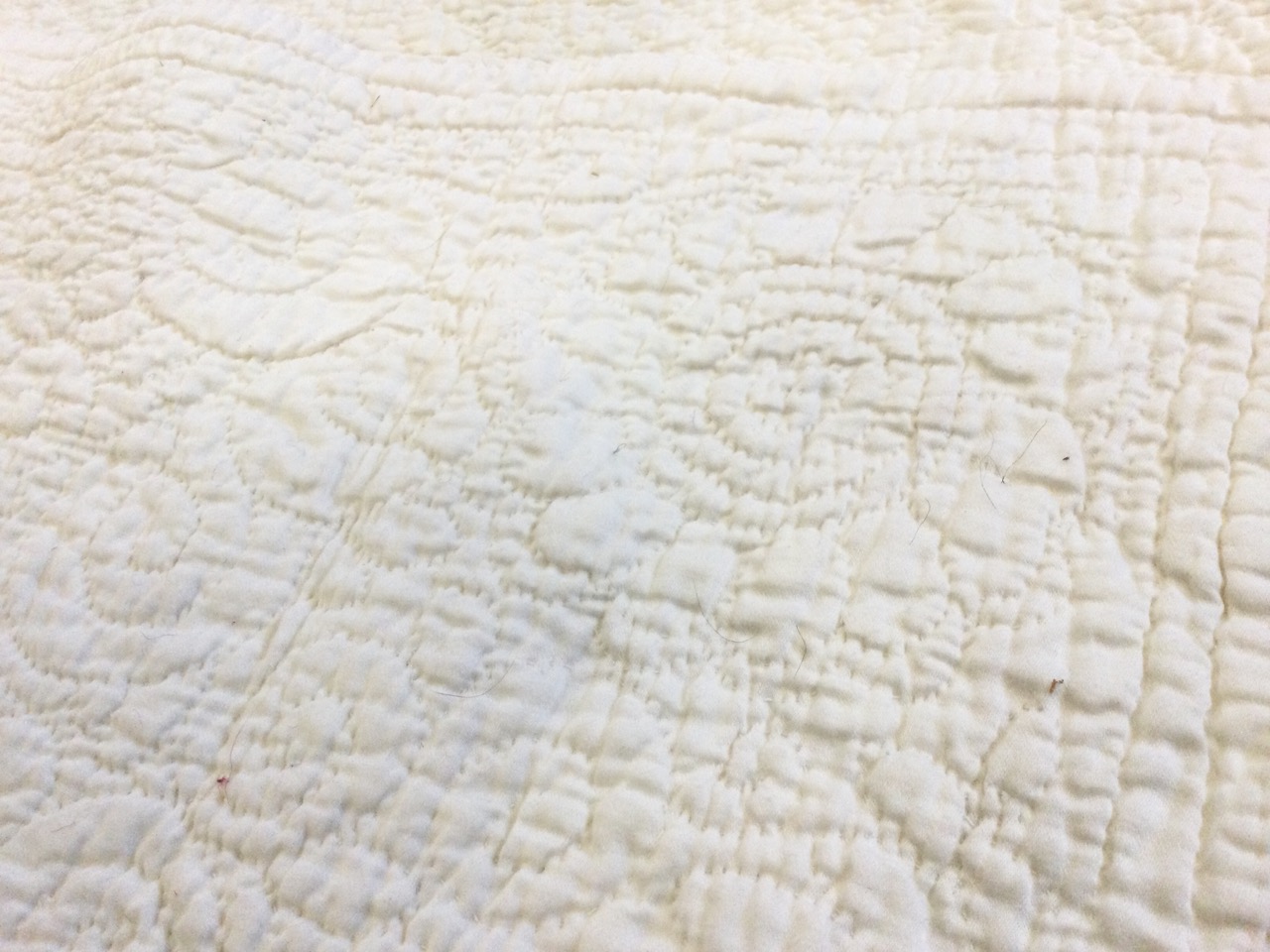 A large white cotton Durham quilt, hand-sewn in an embossed floral quilted pattern. (78in x 104in) - Image 3 of 3