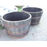 A pair of oak barrel tubs, the staves each bound by three riveted metal strap bands. (26in x 17.5in)