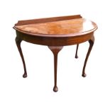 A D-shaped mahogany side table with moulded top above a plain apron, raised on cabriole legs with