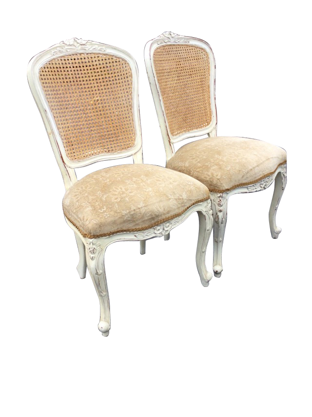 A pair of painted Louis VI style side chairs, the cane backs with floral carving above sprung