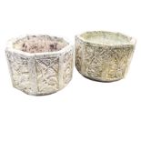 A pair of octagonal composition stone garden pots cast with floral panels to sides. (16.75in x 11in)