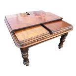 A Victorian mahogany drawer-leaf dining table, the rectangular moulded top with rounded corners