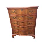 A mahogany serpentine fronted chest of drawers, the crossbanded top above five cockbeaded drawers