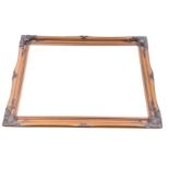 A contemporary bevelled mirror in bronzed swept composition frame with acanthus scrolled corners and