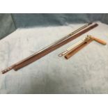 A long leather cased dipping thermometer with brass tube, the top with ring hook - 39.5in; and