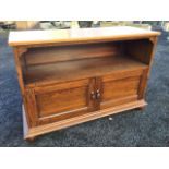 An Edwardian mahogany cabinet with alterations, the later rectangular top above an open