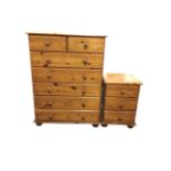 A reproduction Victorian style pine chest of drawers with two short above five long knobbed drawers,
