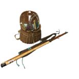 A cane fishing creel containing miscellaneous angling tackle including reels, nylon, floats, lead, a