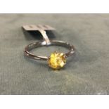 A platinum ring claw set with single yellow sapphire. (.25in)