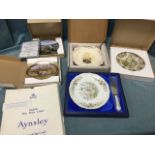 A mint & boxed Aynsley floral plate with slice; and four boxed collectors plates. (5)