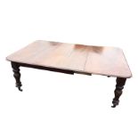 A Victorian mahogany dining table, the rectangular extending moulded top with leaf, raised on