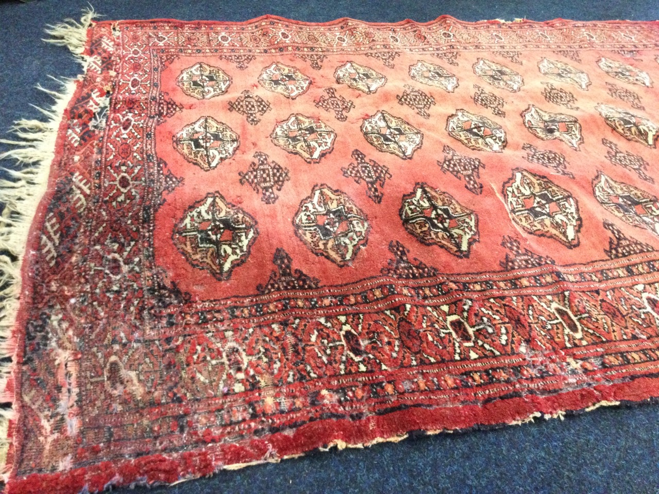 A Tekke rug woven with field of lozenge medallions on madder ground, framed by frieze of geometric - Image 2 of 3