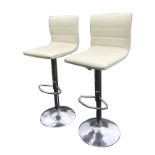 A pair of contemporary Italian ivory leather style rise-and-fall stool/chairs, with upholstered