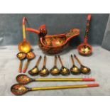 A handpainted Russian strawberry bowl in the form of a duck with eight spoons, two pairs of