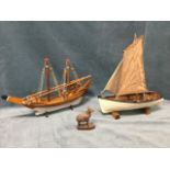 A painted clinker built model boat with sails, oars, lobster pot, lifebelt, etc; another handmade