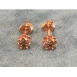A pair of 9ct rose gold ear studs with natural fancy champagne diamonds, the brilliant cut stones in