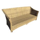 A faux cane sofa, the seat with rectangular back and downswept arms having platted trim edge, raised