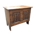 A small oak coffer of nailed construction with hinged lid above carved linenfold panels, the sides