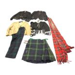 Three formal Scottish dress outfits with buttoned jackets, a waistcoat, a tweed jacket, a pleated