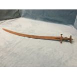A rusty old Indian tulwar sword with channeled curved blade, cross guard and hat-shaped pommel. (