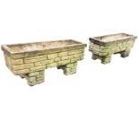 A pair of rectangular composition stone garden planters moulded as brickwork with square rims,