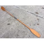 An 8ft old pine canoe paddle with unlaminated fins, the two pieces joined by copper collar. (96in)