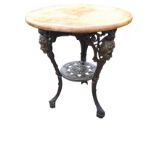 A circular Victorian mahogany table on cast iron supports by Gaskell & Chambers Ltd, the waisted