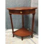 A small mahogany corner table with triangular moulded top above a frieze drawer mounted with brass