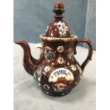 A Victorian bargeware teapot & cover, with applied floral sprigwork decoration on treacle glazed
