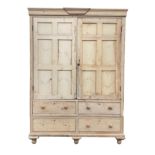 A large Victorian pine housekeepers cupboard, the cornice with applied central moulding above