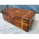 A Victorian walnut writing box with brass banding and escutcheon, having ebonised corner mouldings -