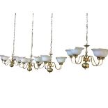 A set of four Dutch style hanging brass ceiling lights, the columns hung from chains with bulbous